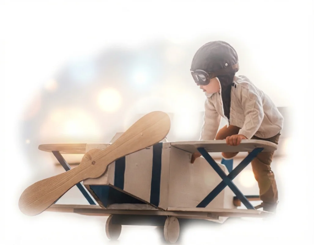 Niño jugando con un avión de cartón